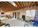 Unfinished basement with exposed wood beams and partial plastic vapor barrier on the walls at 40900 Red Fox Cir, Elizabeth, CO 80107