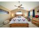 Cozy bedroom with a comfortable bed, ceiling fan and decorative quilt at 40900 Red Fox Cir, Elizabeth, CO 80107