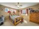 Bedroom featuring a double bed, dresser, windows, ceiling fan and carpeted floor at 40900 Red Fox Cir, Elizabeth, CO 80107