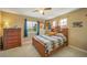 Bedroom featuring a full bed, dresser, windows, ceiling fan and carpeted floor at 40900 Red Fox Cir, Elizabeth, CO 80107