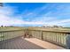 Expansive deck with wood railing, offering scenic views of the surrounding landscape and blue skies at 40900 Red Fox Cir, Elizabeth, CO 80107