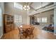 Bright dining room with hardwood floors, a wooden table, a fireplace, and access to other living areas at 40900 Red Fox Cir, Elizabeth, CO 80107