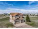 Two-story home with a three-car garage, a brown roof, and neutral colored siding at 40900 Red Fox Cir, Elizabeth, CO 80107