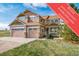 Inviting two-story home with a three-car garage and charming front porch at 40900 Red Fox Cir, Elizabeth, CO 80107