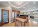 Open kitchen with stainless steel refrigerator, pantry, and a wooden island leading into the living space at 40900 Red Fox Cir, Elizabeth, CO 80107