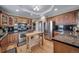 Well-equipped kitchen with stainless steel appliances, wood cabinets, granite countertops, and a functional wooden island at 40900 Red Fox Cir, Elizabeth, CO 80107