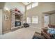 Bright living room featuring a tall stone fireplace and large windows for plenty of natural light at 40900 Red Fox Cir, Elizabeth, CO 80107