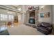 Inviting living room features a stone fireplace and adjoining dining area with ample natural light at 40900 Red Fox Cir, Elizabeth, CO 80107