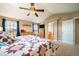 Main bedroom with a vaulted ceiling, two windows, a dresser, and archway to bathroom at 40900 Red Fox Cir, Elizabeth, CO 80107