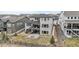 Aerial view of the backyard with an outdoor patio, fire pit, and grass at 7077 Copper Sky Cir, Castle Pines, CO 80108