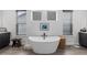 Elegant bathroom featuring a freestanding tub, stylish fixtures, and serene decor at 7077 Copper Sky Cir, Castle Pines, CO 80108