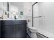 Sleek bathroom with a modern vanity, dark fixtures, and a stylish glass-enclosed shower, blending form and function at 7077 Copper Sky Cir, Castle Pines, CO 80108