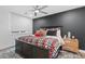 Modern bedroom with a dark accent wall, plush bedding, and natural light at 7077 Copper Sky Cir, Castle Pines, CO 80108
