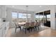 Bright dining room with large windows, stylish lighting, and a scenic view at 7077 Copper Sky Cir, Castle Pines, CO 80108