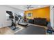 Bright exercise room featuring a treadmill, stationary bike, and weights at 7077 Copper Sky Cir, Castle Pines, CO 80108