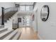 Bright foyer with staircase, and light hardwood floors at 7077 Copper Sky Cir, Castle Pines, CO 80108