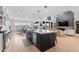 Open-concept kitchen with island, stainless steel appliances, and seamless flow into living spaces at 7077 Copper Sky Cir, Castle Pines, CO 80108