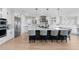 A modern kitchen features a large island, stainless steel appliances, and stylish pendant lighting at 7077 Copper Sky Cir, Castle Pines, CO 80108
