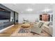 Modern living room with a fireplace, large TV, comfortable seating and a colorful area rug at 7077 Copper Sky Cir, Castle Pines, CO 80108