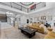 Elegant living room with open floor plan, modern kitchen, and a striking upper-level view at 7077 Copper Sky Cir, Castle Pines, CO 80108