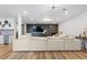 Open-concept living room with modern fireplace, sleek shelving, and a large sectional sofa at 7077 Copper Sky Cir, Castle Pines, CO 80108