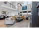 An expansive living room with ample seating and great natural light from the oversized windows at 7077 Copper Sky Cir, Castle Pines, CO 80108