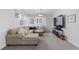 Comfortable living room featuring a plush sectional sofa, media center, and natural light at 7077 Copper Sky Cir, Castle Pines, CO 80108