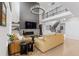 Bright living room boasts fireplace, hardwood floors, and elegant chandelier at 7077 Copper Sky Cir, Castle Pines, CO 80108