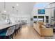 Bright living area with kitchen, dining, and living room featuring hardwood floors at 7077 Copper Sky Cir, Castle Pines, CO 80108