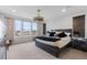 Serene main bedroom featuring ample natural light, a large bed, and modern furnishings at 7077 Copper Sky Cir, Castle Pines, CO 80108