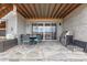 Covered patio with a dining table, comfortable seating, and a built-in grill at 7077 Copper Sky Cir, Castle Pines, CO 80108