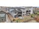 The rear exterior of this home boasts a stone patio, ample backyard space, and a second story covered deck at 7077 Copper Sky Cir, Castle Pines, CO 80108