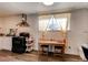 Compact kitchen featuring wooden table, chairs and modern black gas range at 6800 E Tennessee Ave # 461, Denver, CO 80224