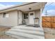 Covered back porch featuring neutral walls, dual doors, and steps down to backyard at 4810 W 8Th Ave, Denver, CO 80204