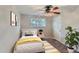 Cozy bedroom with a bright window, ceiling fan, neutral walls, and stylish decor for a relaxing retreat at 4810 W 8Th Ave, Denver, CO 80204