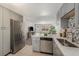 Open kitchen with stainless steel appliances, quartz countertops, and easy access to the living area for seamless entertaining at 4810 W 8Th Ave, Denver, CO 80204