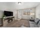 Comfortable living room with a cozy fireplace, large TV, and ample seating space, great for relaxation and entertainment at 4810 W 8Th Ave, Denver, CO 80204