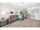 Inviting living room featuring plush carpet, a comfortable sofa, and an open flow to the kitchen and breakfast bar at 4810 W 8Th Ave, Denver, CO 80204