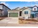 New construction home with a two-car garage and landscaped front yard at 8589 Eckley St, Littleton, CO 80125