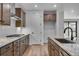 Modern kitchen with wood cabinets, granite countertops and stainless steel appliances at 8589 Eckley St, Littleton, CO 80125