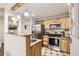 Modern kitchen with stainless steel appliances, granite countertops, wood cabinetry, and ample counter space at 14602 E 2Nd Ave # 303C, Aurora, CO 80011