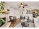 Inviting living room featuring a fireplace, ceiling fan, wood floors, and an open concept layout at 14602 E 2Nd Ave # 303C, Aurora, CO 80011