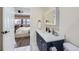 Stylish bathroom leads into bedroom, featuring vanity with framed mirror and adjacent commode at 100 Park W Ave # 605, Denver, CO 80205