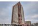 Tall building with an orange and cream color scheme, with multiple floors and balconies at 100 Park W Ave # 605, Denver, CO 80205