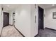 Well-lit hallway with modern carpeting, access to elevators, and convenient laundry facilities at 100 Park W Ave # 605, Denver, CO 80205