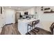 Kitchen features stainless steel appliances, quartz countertops, and bar seating area at 100 Park W Ave # 605, Denver, CO 80205