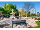 A well-maintained park with lush greenery, a bench, and a serene fountain at 100 Park W Ave # 605, Denver, CO 80205