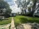 Spacious backyard with a shed, lawn, large trees and partial patio at 260 Sheridan Blvd, Denver, CO 80226