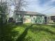 Backyard with lawn has a green home with white trim at 260 Sheridan Blvd, Denver, CO 80226