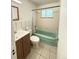 Modest bathroom features tiled walls, a vanity with sink, and a shower-tub combination at 260 Sheridan Blvd, Denver, CO 80226